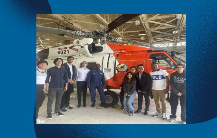 Group photo in front of a helicopter of the interdisciplinary student team in Innovation for National Security (i4NS) program who worked with a drug and human trafficking prevention unit