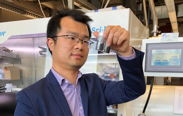 Assistant Professor Zheng Chen, UC San Diego, comparing materials samples.